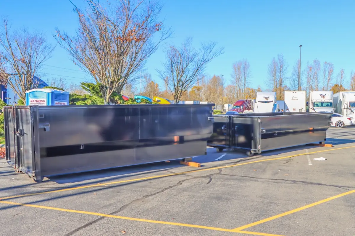 Professional dumpster rental service with roll-off container on residential driveway in Moab